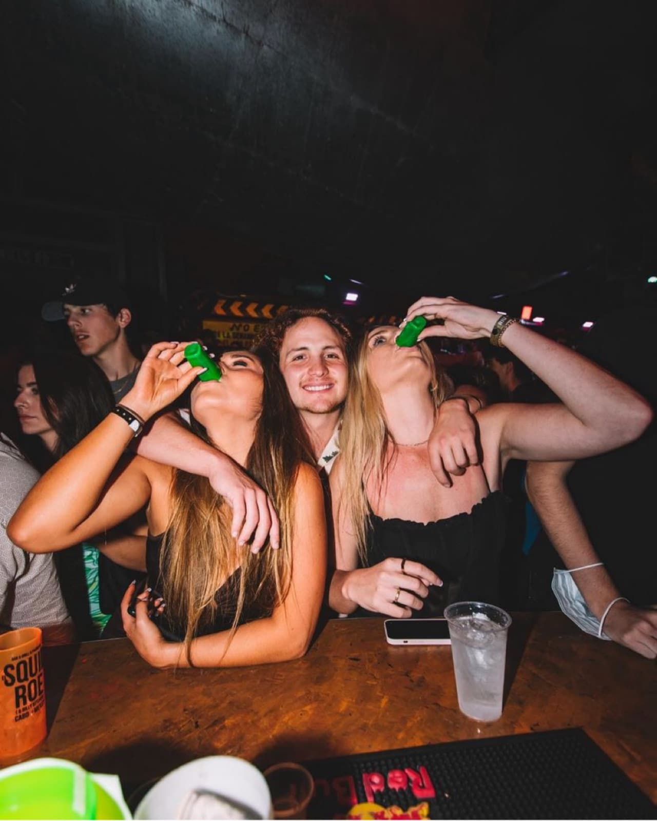 Friends taking shots at the bar at El Squid Roe Cabo San Lucas