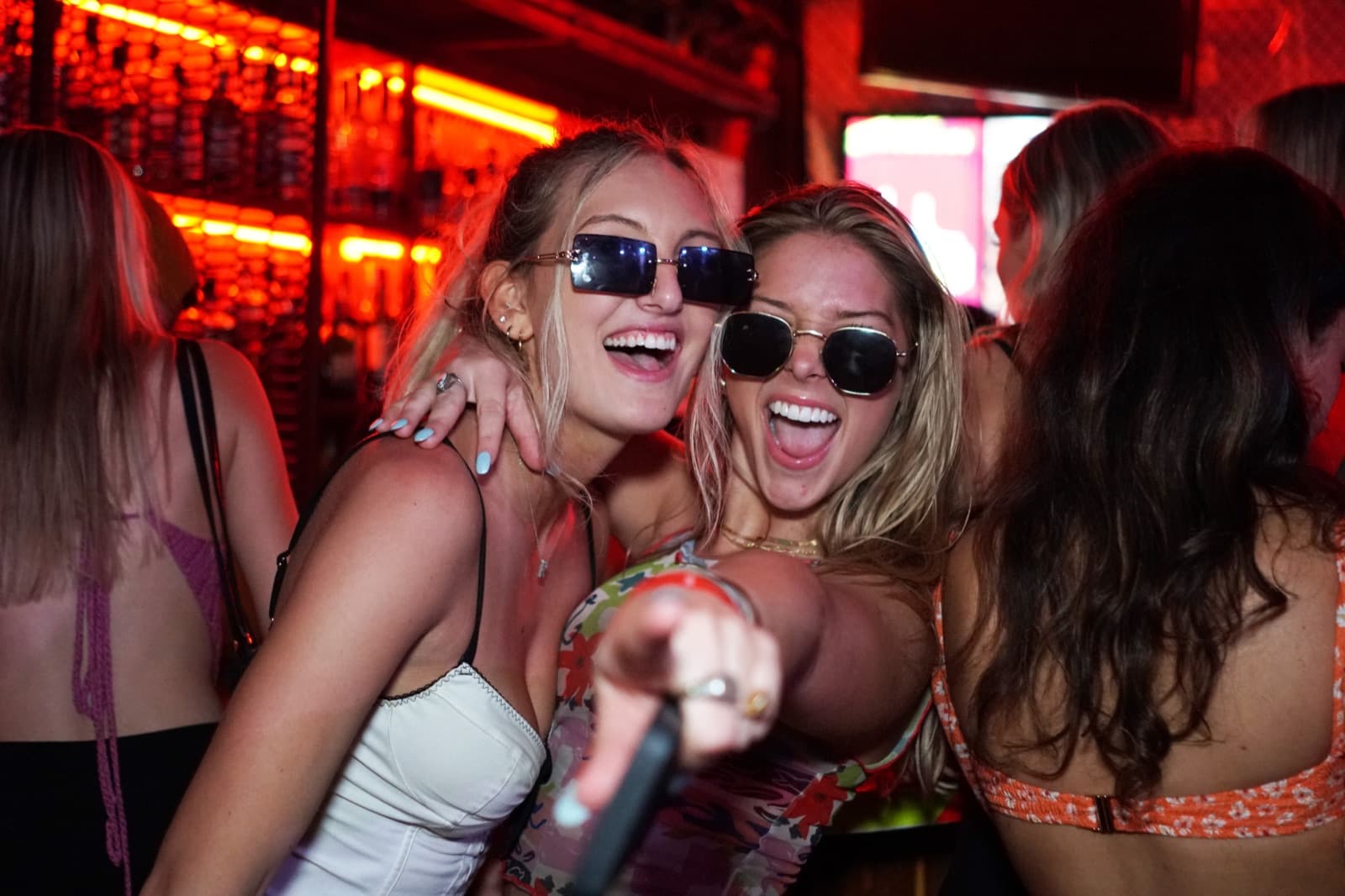Girls laughing in sunglasses on spring break at El Squid Roe Cabo