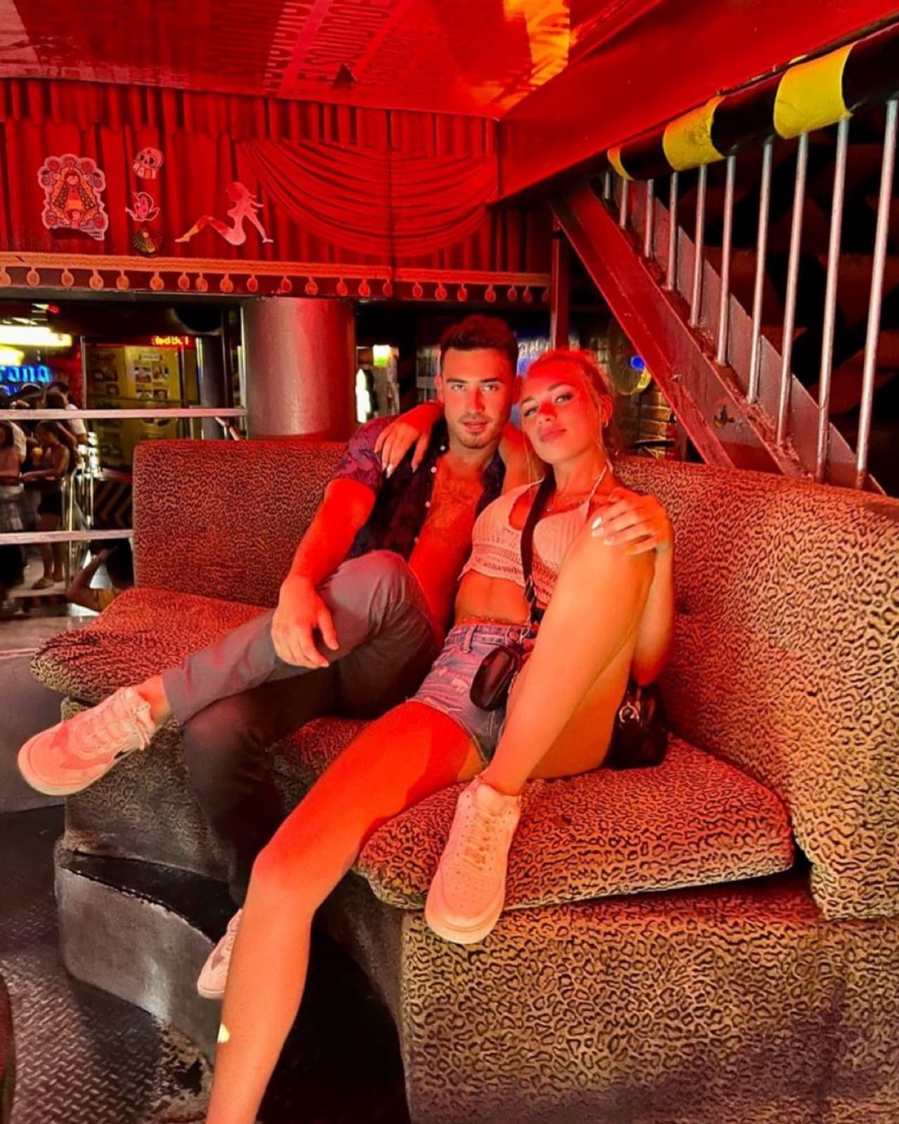 Couple in the leopard-print VIP lounge at El Squid Roe Cabo