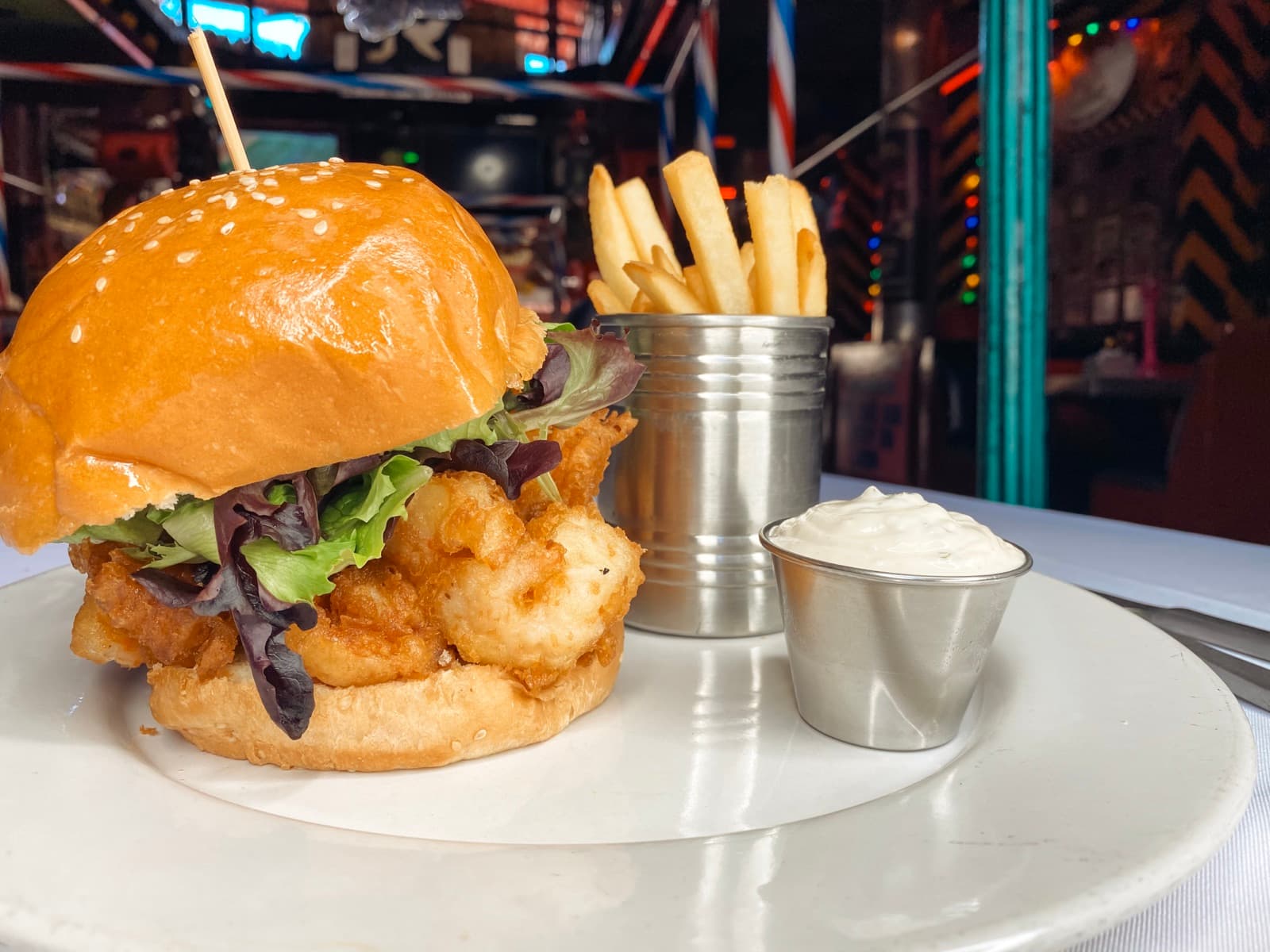 Crispy shrimp po'boy sandwich with fries at El Squid Roe restaurant in Cabo San Lucas