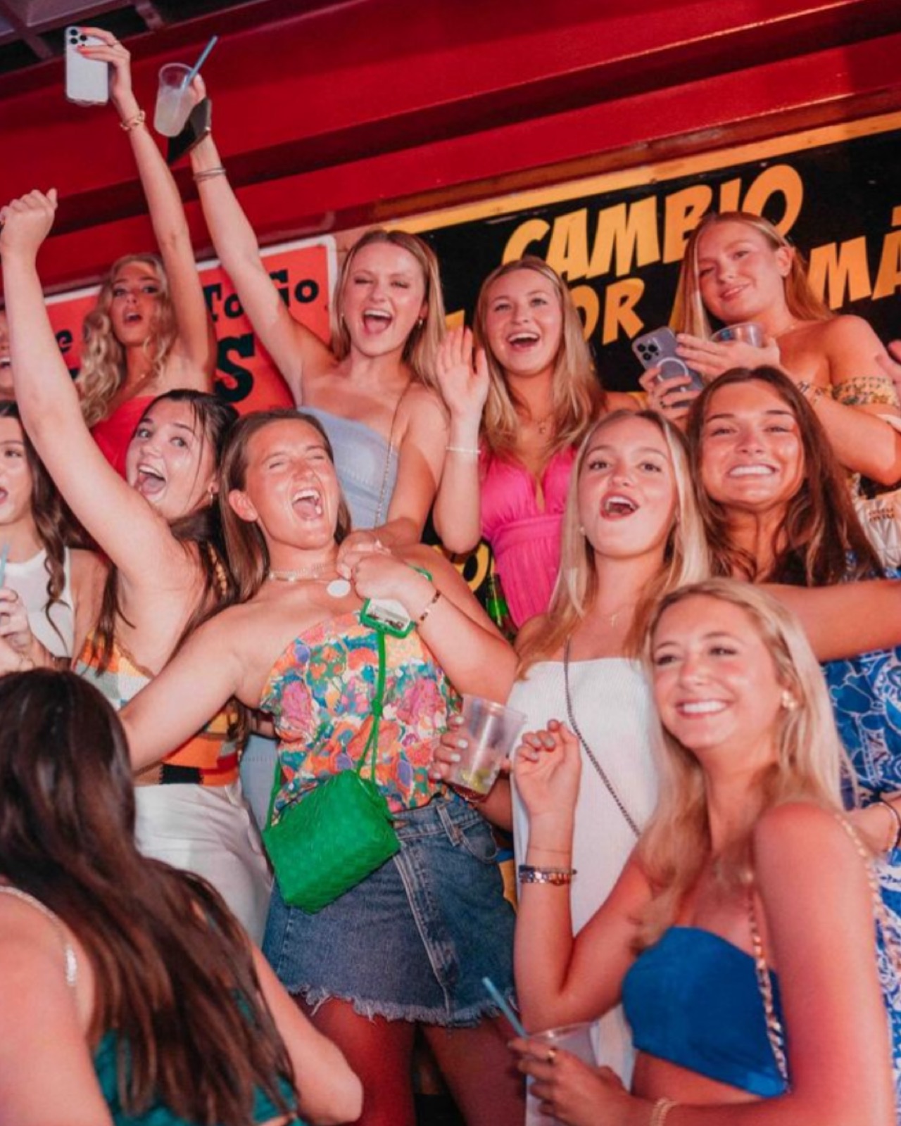 Bachelorette party group dancing together at El Squid Roe during a Cabo bachelorette party