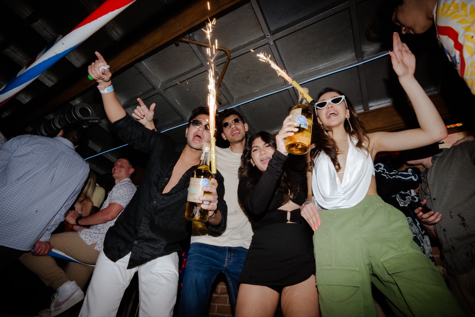 Bottle service arriving with sparklers and champagne for a birthday celebration at El Squid Roe in Cabo San Lucas