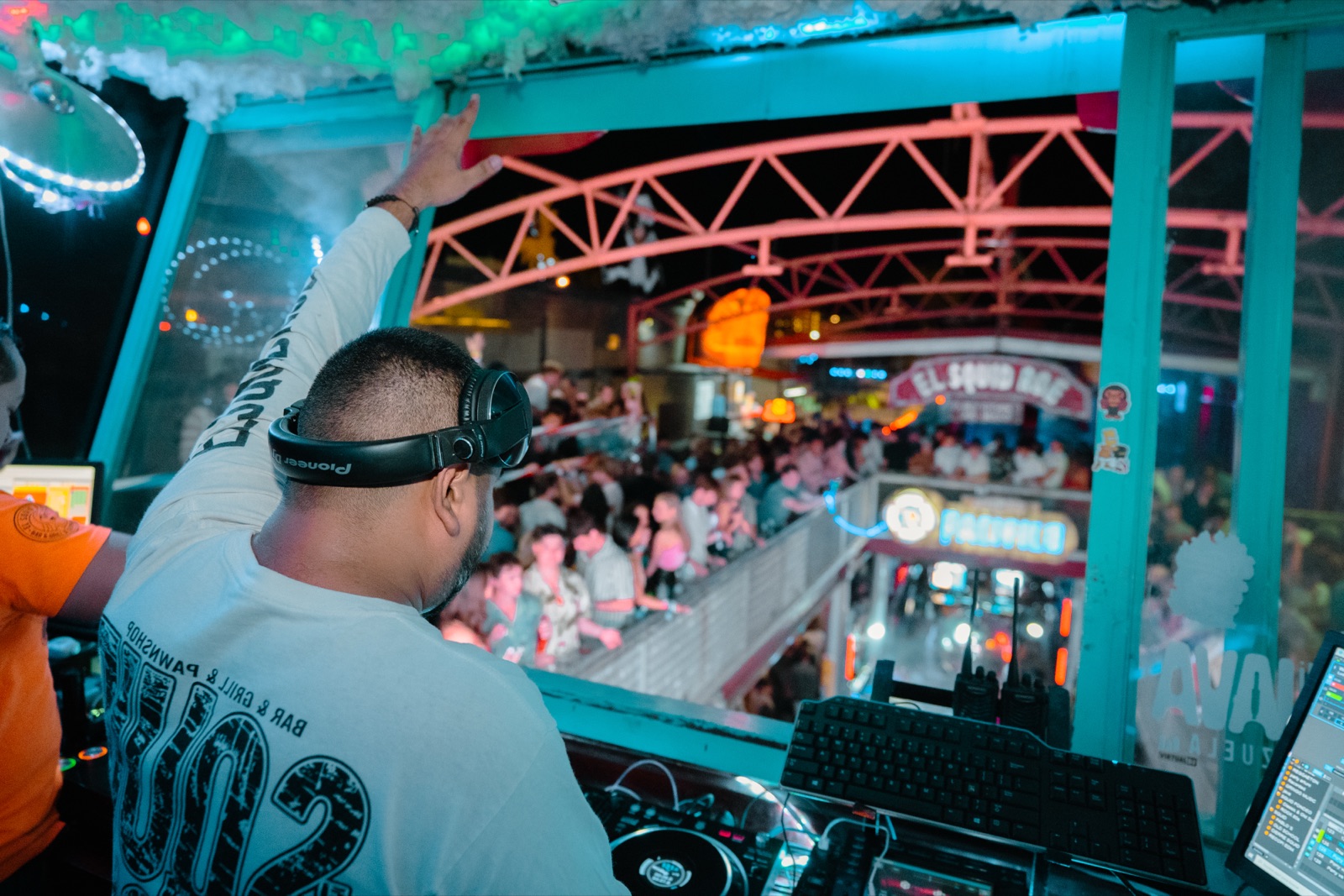 Crowd dancing in front of the DJ booth at El Squid Roe, the must-do thing to do in Cabo San Lucas at night