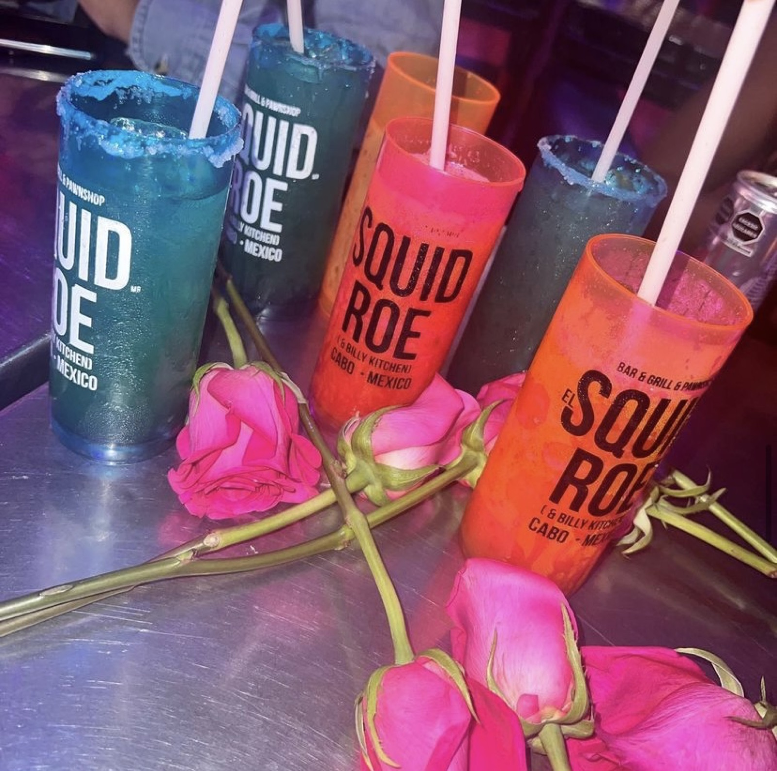 Margaritas in souvenir cups at El Squid Roe in Cabo San Lucas